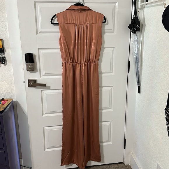 This silky romper is super cute. I am 5’5” & 135 lbs. it’s a salmon/ginger color - Picture 5 of 7